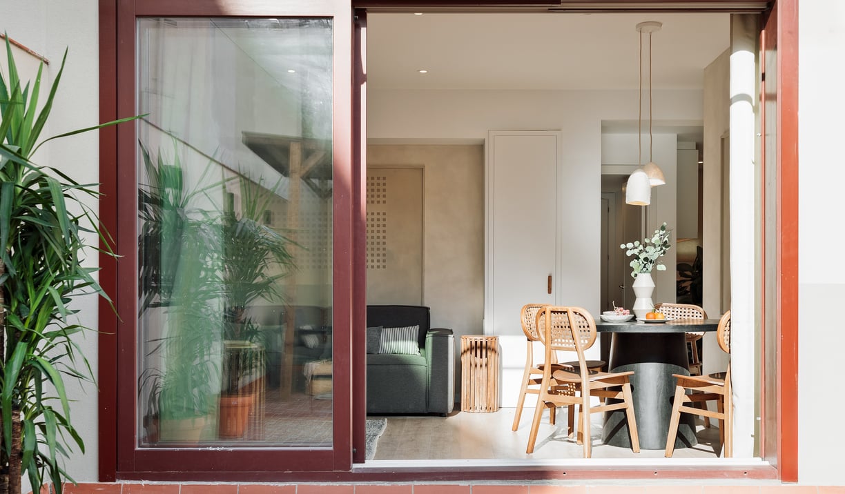 Modern dining area and terrace with sleek design elements and natural wood accents