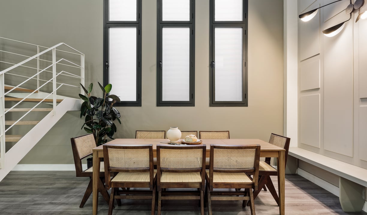Contemporary dining room with a minimalist design, rattan furniture, neutral colors in Barcelona