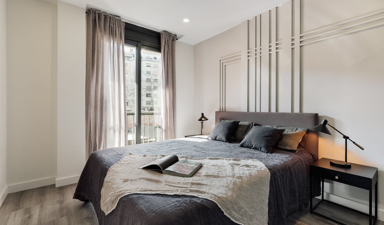 Elegant bedroom with wall panels, calm color palette and modern minimalist design in Barcelona