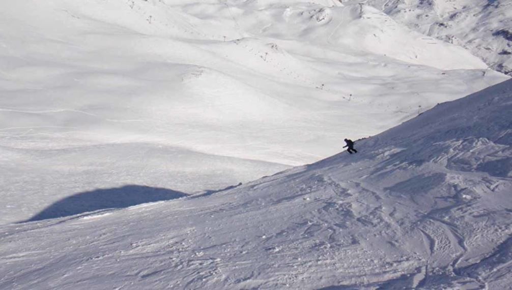 The easy ski-out at the end across the plateau is in sight after skiing this final slope