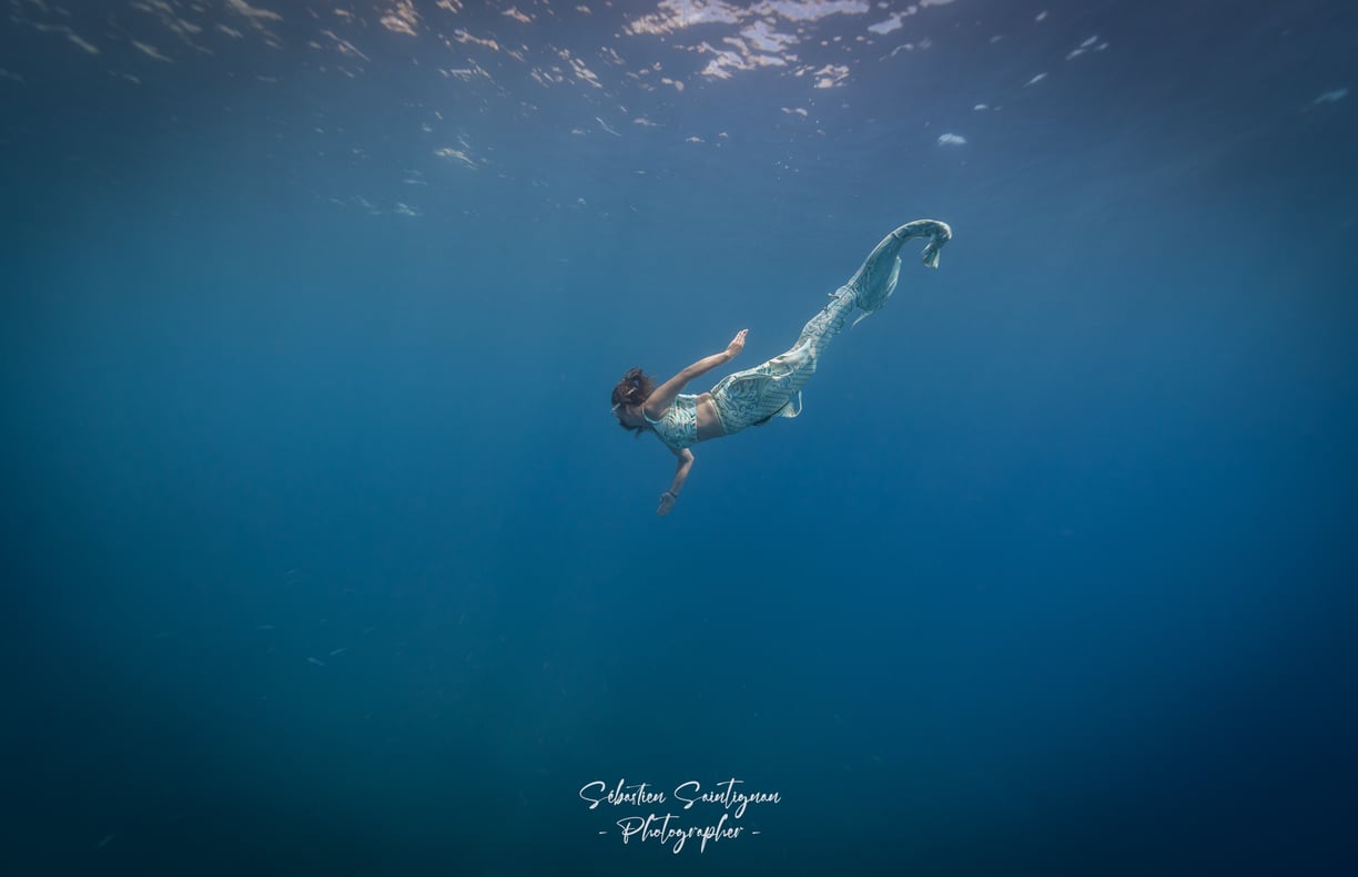 Mermaid swimming peacefully in the sea. Photo taken by Sébastien Saintignan