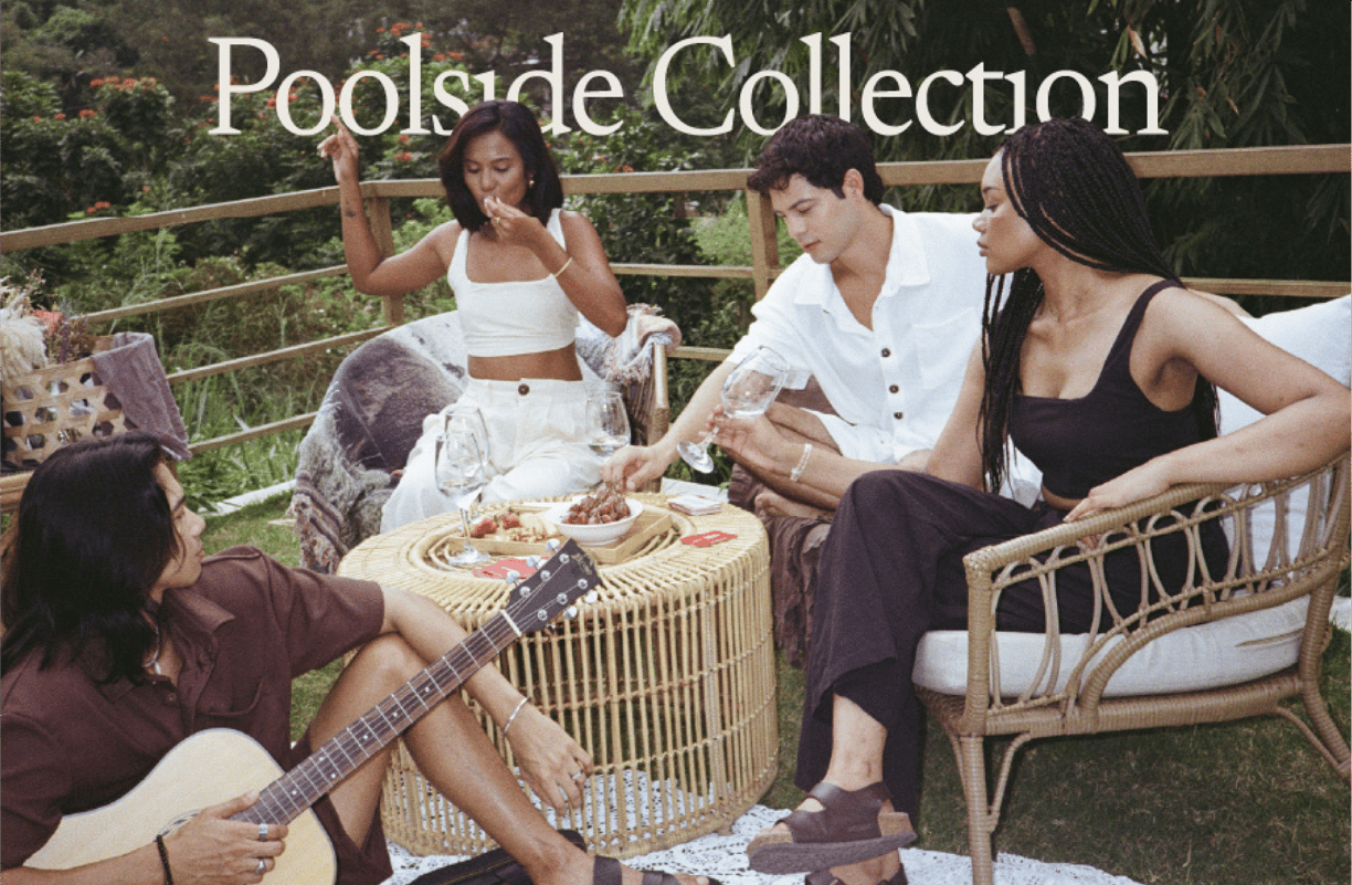 a group of people sitting around a table with a guitar
