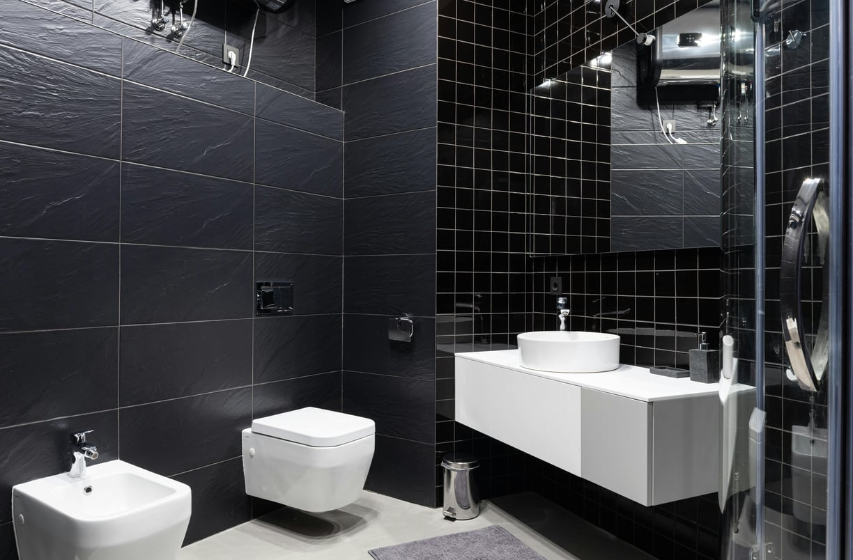Modern bathroom display of premium sanitaryware items including wash basin, toilet, and faucet at Gulf Ceramics showroom 