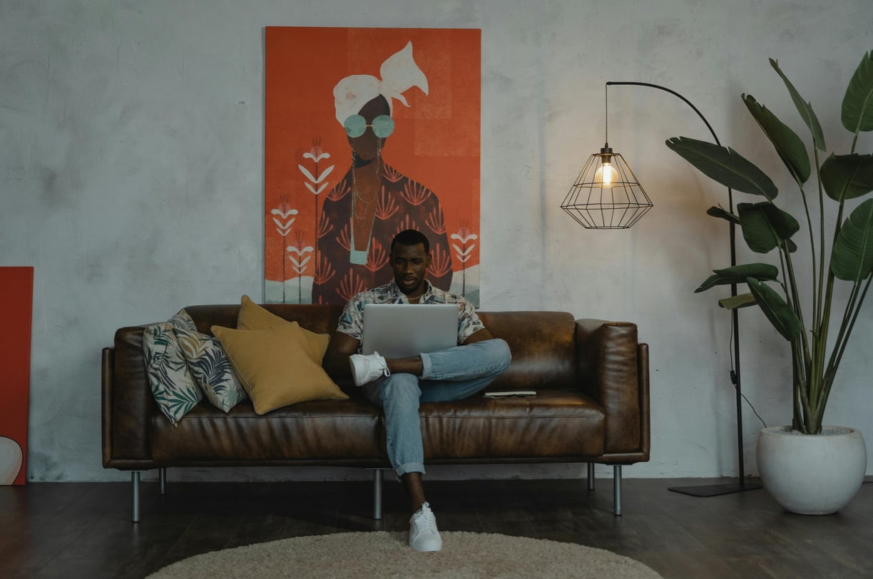 Man in Blue Denim Jeans Sitting on Brown Couch by Tima Miroshnichenko From Pexels