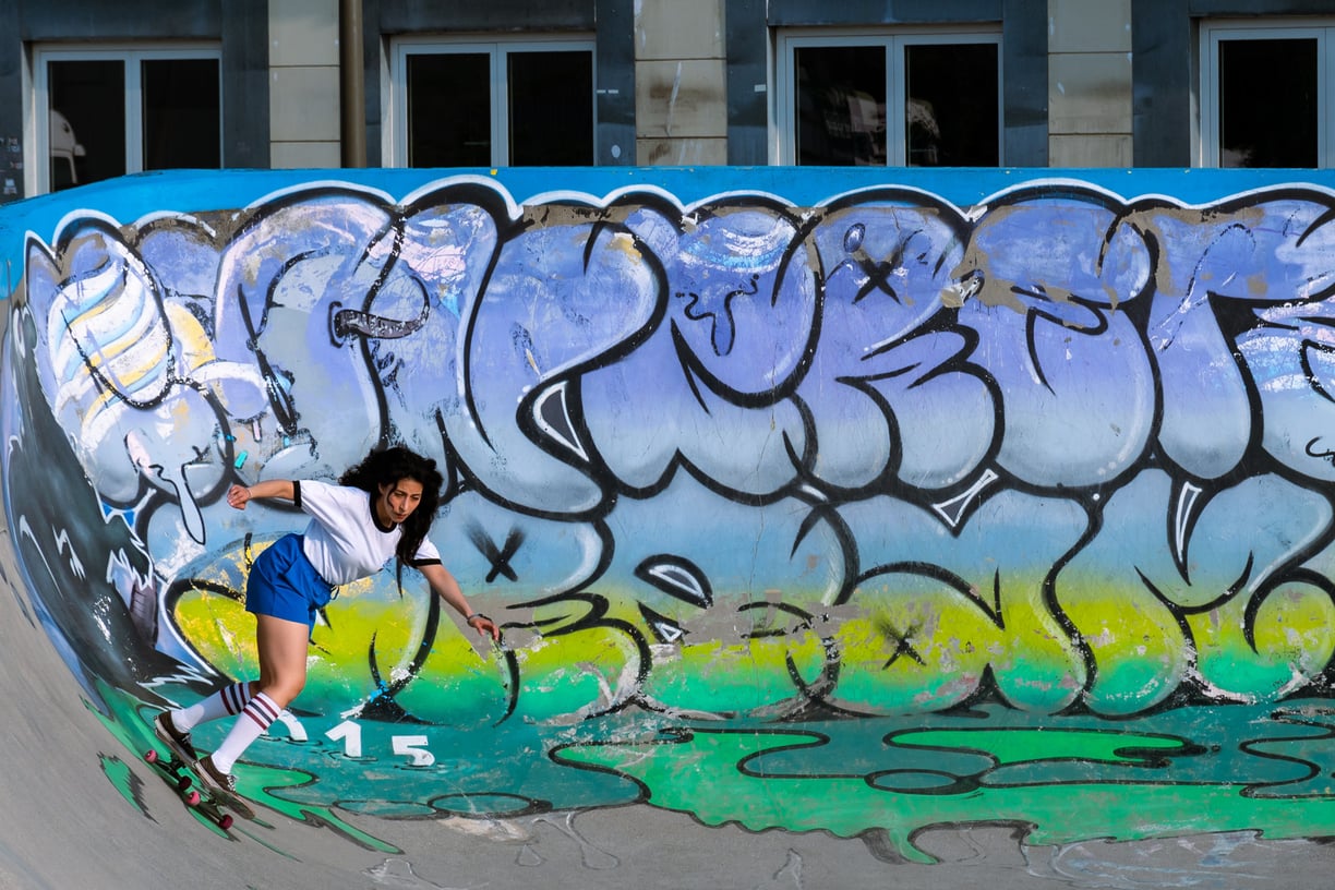 a skateboarder is riding her skateboard on a ramp