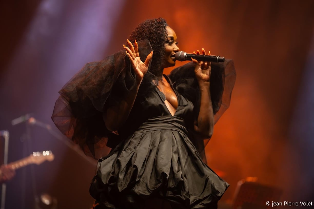 a woman in a black dress and a microphone