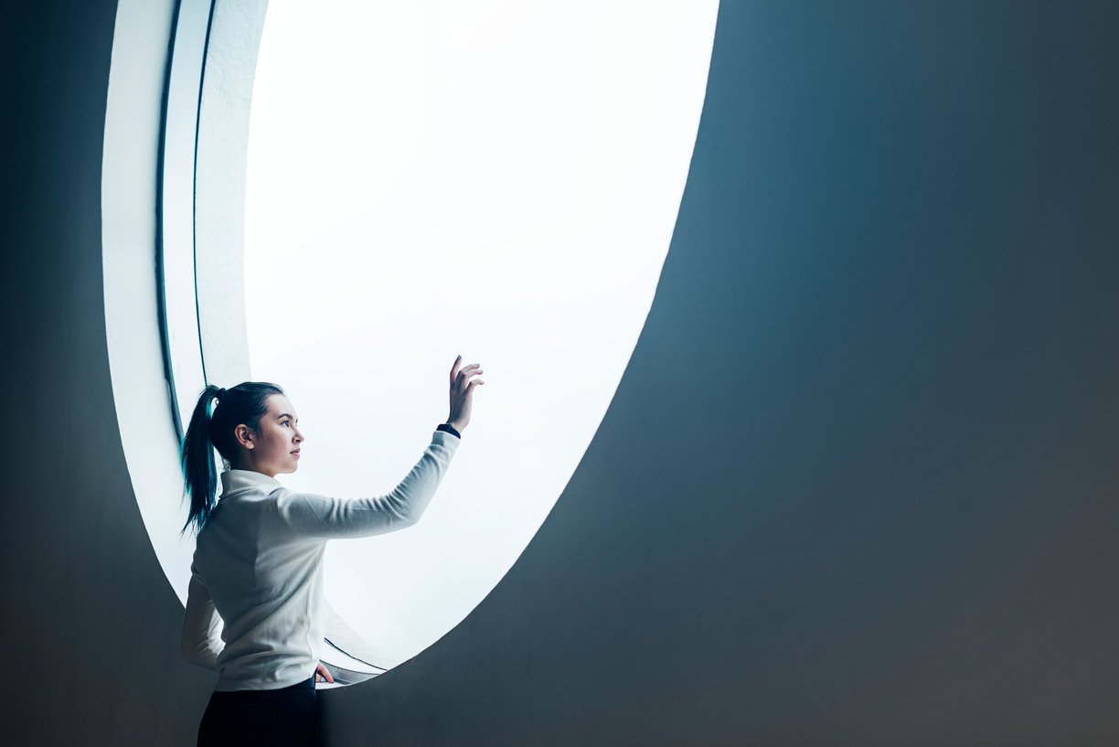 Image of a lady uing a touchscreen to find out more about herself, gain clarity and purpose