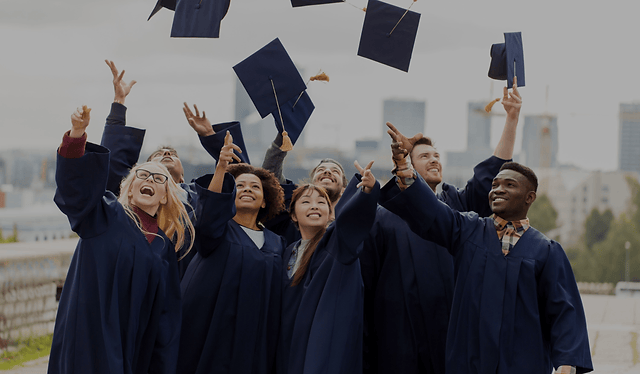 a group of people in graduation gowns throwing their caps