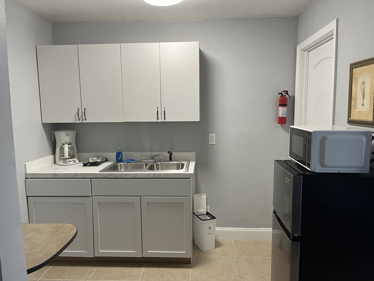 a kitchen with a sink, microwave, and refrigerator