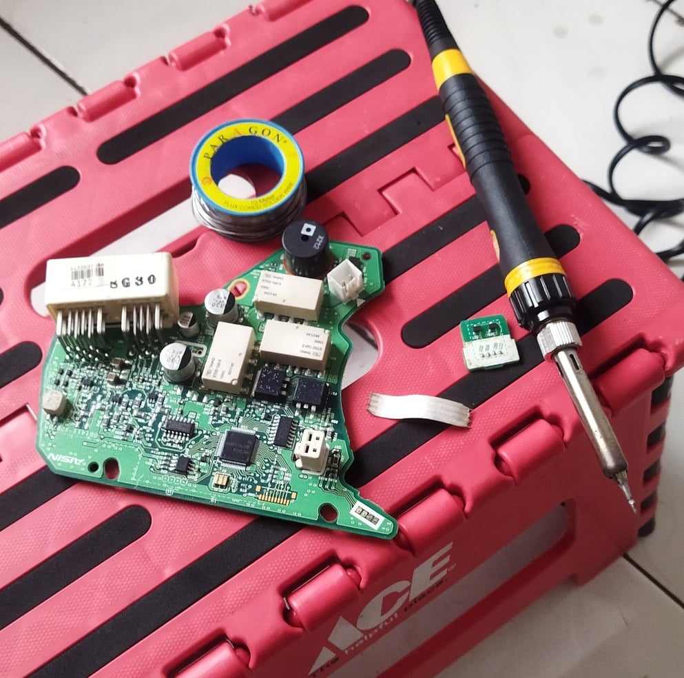 a pink box with a computer mouse and a pair of scissors