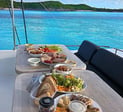 a table with a plate of food and a bottle of beer