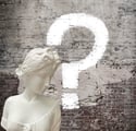 a white marble busturine with question mark on it