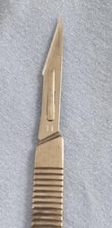 a knife and a knife blade on a blue cloth