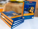 a stack of books with a lion on the cover