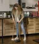 woman sweeping kitchen floor