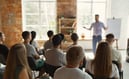 a man in a white shirt giving a training session about sustainability
