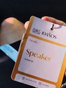 a person holding a badge with a name tag on it Dra Flavia Ward