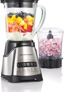 a blender with fruit in a blender