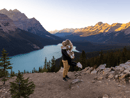 a couple standing on a mountain top with Peyto Lake in the background