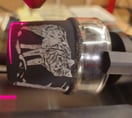 Ein kleine Trinkglas, schwarz angemalt und mit einem Wolf Motiv