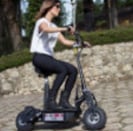 a woman riding a scooter in a park