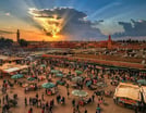 a large group of people standing around a market
