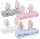 a set of four bunny ears in various colors of pink, blue and white