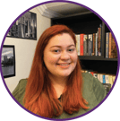 a woman with red hair and a green shirt