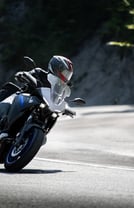 a person riding a motorcycle on a road