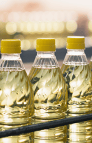 a row of bottles of oil on a shelf