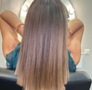 a woman with long hair and a balayage natural 