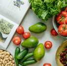 Photo of an open cookbook next to colorful ingredients