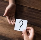 a person holding a card game card game