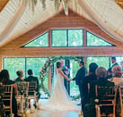 Couple and David Allbut Celebrant Conducting Their Ceremony