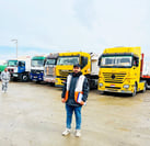 a man standing in front of a group of trucks
