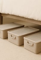 Three rectangular fabric bins with clear lids neatly tucked under a bed for smart, hidden storage.