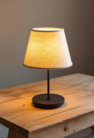 A sleek, modern cordless lamp with a warm glow rests on a small table.