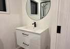 Bathroom vanity with large round mirror