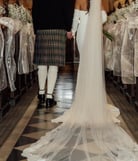 a bride and groom are standing in a church