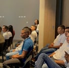 a man standing in front of a room full of people