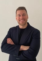 a man in a suit and tie smiling