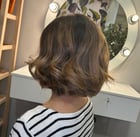 a woman with a short haircut and a balayage color