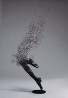 a sculpture of a horse running through a field
