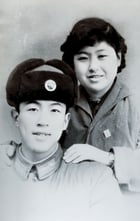 a man and woman in uniform posing for a photo