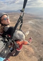 A passenger with sunglasses flying with a professional pilot in Marrakech