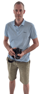 a man holding a camera and taking a picture