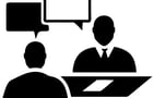 a man and woman sitting at a desk with speech bubbles