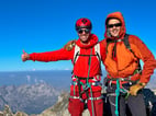 Alpinists smiling on the top of Monta Disgrazia. Valmasino, Italy