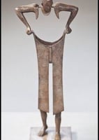a bronze statue of a man with a hat on
