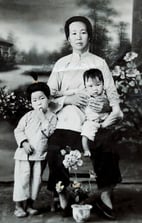 a woman in a white shirt and two children